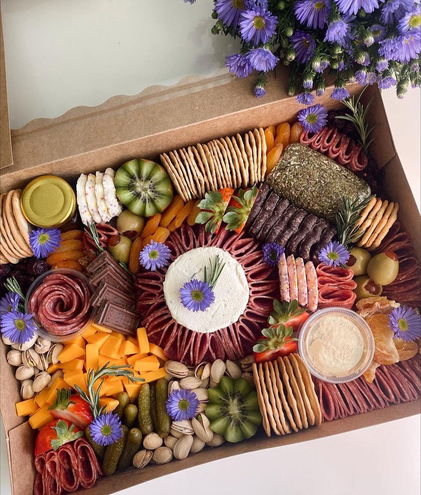Full indoor grazing table spread with charcuterie and cheese