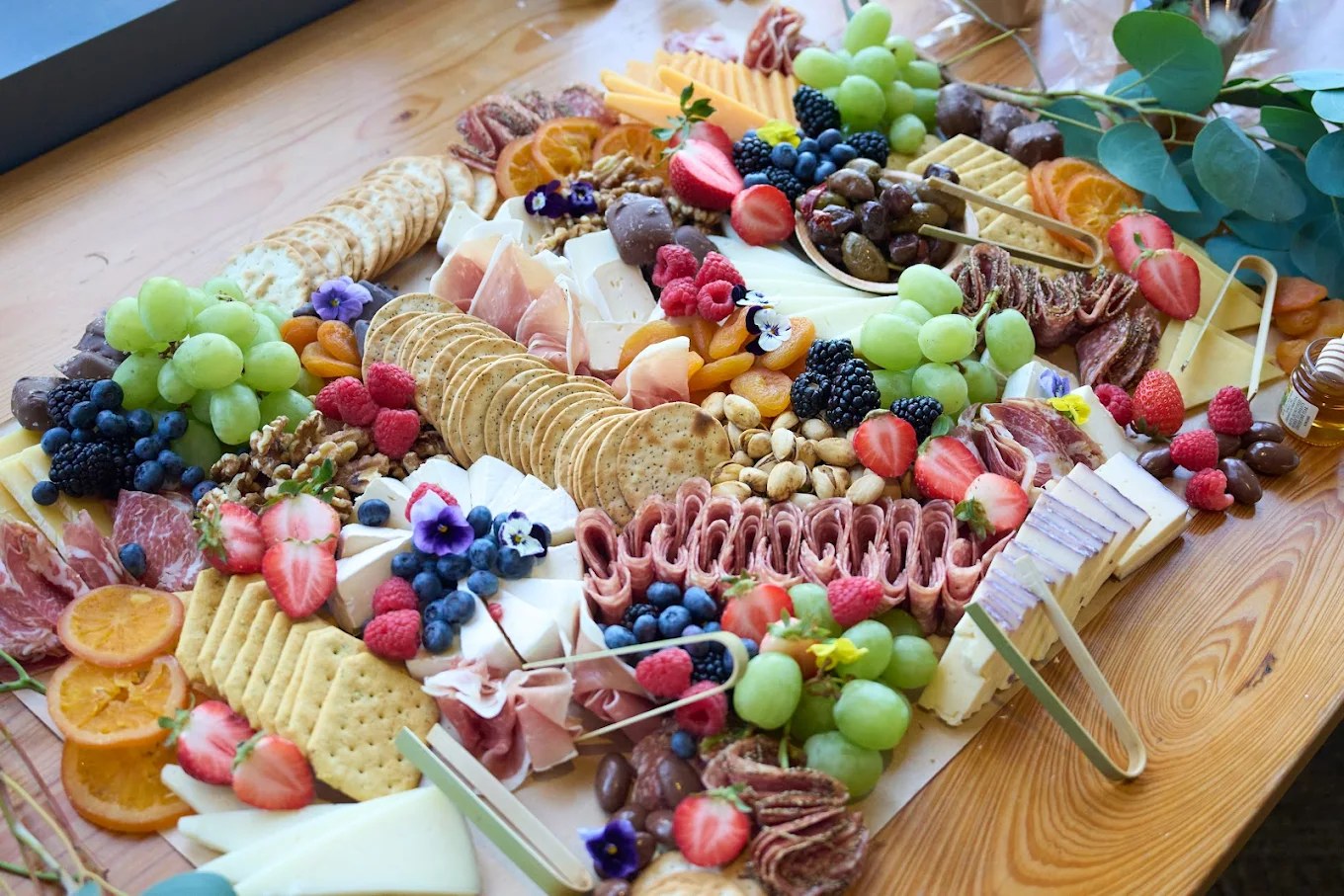 Artisan grazing table with fresh fruit and charcuterie